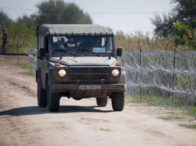 SZEGED, HUNGARY - AUGUST 30: Hungarian army patrol the border from Serbia into Hungary close to the village of Roszke on August 30, 2015 near Szeged, Hungary. According to the Hungarian authorities a record number of migrants from many parts of the Middle East, Africa and Asia crossed the border from Serbia earlier this week, said to be due in part to the erection of a new fence that is due to be completed at the end of this month. Since the beginning of 2015 the numbe