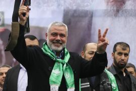 Senior Hamas leader Ismail Haniyeh holds a weapon during a military parade by al-Qassam Brigades, the armed wing of the Hamas movement, in Gaza City December 14, 2014. The parade was held to mark the 27th anniversary of Hamas' founding. REUTERS/Mohammed Salem (GAZA - Tags: POLITICS MILITARY ANNIVERSARY PROFILE)