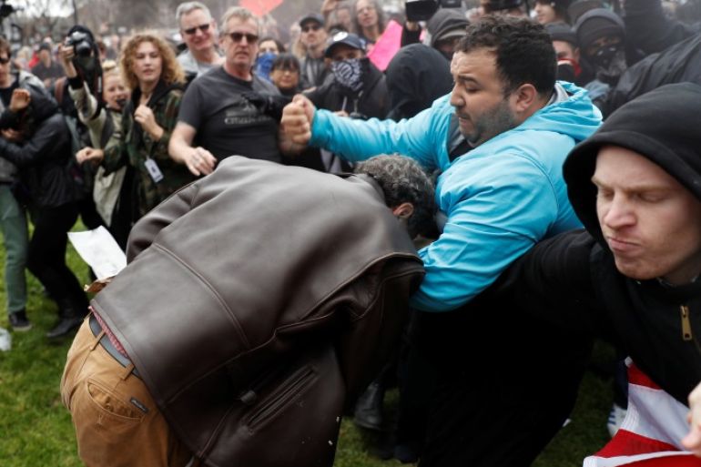A demonstrator in support of U.S. President Donald Trump (L) scuffles with a counter-protester during a