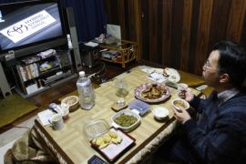 Toyota Motor Corp employee Kazuo Akatsuka, a worker at the Tsutsumi plant which assembles Prius sedans, watches television reporting news of his company as he eats dinner alone at his house in Toyota, central Japan, early February 9, 2010. Akatsuka, 55, lives a life that is dominated, for better or worse, by his employer, Toyota, and right now it's got him a little worried. The company is facing its biggest crisis in at least half a century, recalling more than 8.5 million vehicles for faulty brakes and accelerators and facing criticism for its handling of the problems. Picture taken February 9, 2010. REUTERS/Yuriko Nakao (JAPAN)