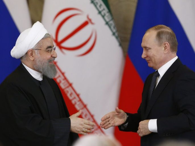 Russian President Vladimir Putin shakes hands with Iranian President Hassan Rouhani during a joint news conference following their meeting at the Kremlin in Moscow, Russia March 28, 2017. REUTERS/Sergei Karpukhin