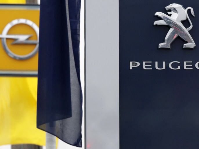 The logos of French car maker Peugeot and German car maker Opel are seen at a dealership in Villepinte, near Paris, France, February 20, 2017. REUTERS/Christian Hartmann