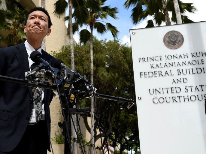 Hawaii Attorney General Douglas Chin answers questions from the media at the U.S. District Court Ninth Circuit after presenting his arguments after filing an amended lawsuit against President Donald Trump's new travel ban in Honolulu, Hawaii, March 15, 2017. REUTERS/Hugh Gentry