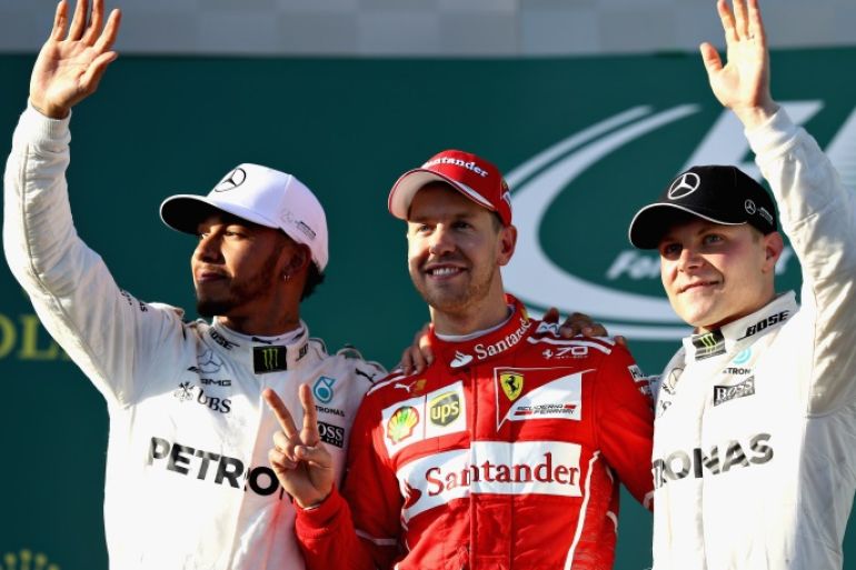MELBOURNE, AUSTRALIA - MARCH 26: Sebastian Vettel of Germany and Ferrari celebrates his win on the podium with second placed Lewis Hamilton of Great Britain and Mercedes GP and Valtteri Bottas of Finland and Mercedes GP during the Australian Formula One Grand Prix at Albert Park on March 26, 2017 in Melbourne, Australia. (Photo by Mark Thompson/Getty Images)