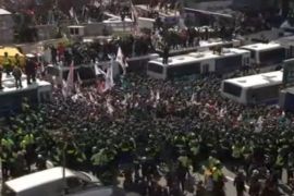 Police surround demonstrators during a protest in front of the Constitutional Court in Seoul, South Korea, in this still image from video, March 10, 2017. REUTERS/via Reuters TV