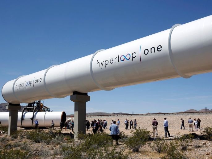 Journalists and guests look over tubes following a propulsion open-air test at Hyperloop One in North Las Vegas, Nevada, U.S. May 11, 2016. REUTERS/Steve Marcus