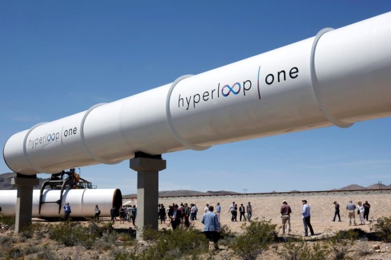 Journalists and guests look over tubes following a propulsion open-air test at Hyperloop One in North Las Vegas, Nevada, U.S. May 11, 2016. REUTERS/Steve Marcus