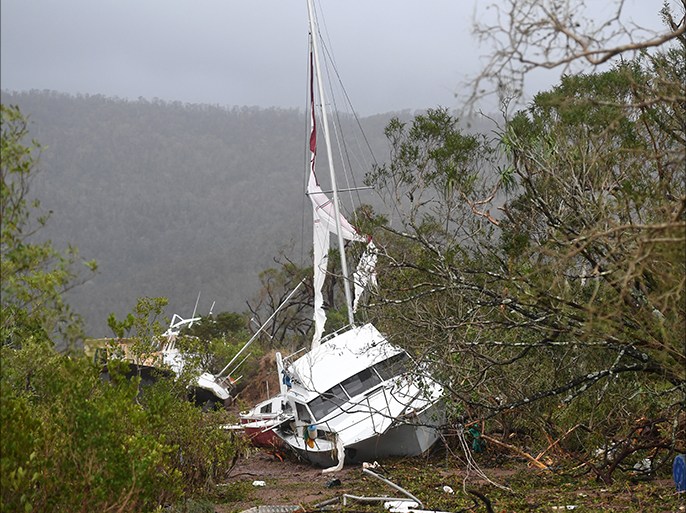 epa05876451 A boat is smashed against the bank at Shute Harbour near Airlie Beach, Queensland, Australia, 29 March 2017. Cyclone Debbie has hit Queensland's far north coast yesterday as a category 4 cyclone, causing wide spread damage. EPA/DAN PELED AUSTRALIA AND NEW ZEALAND OUT