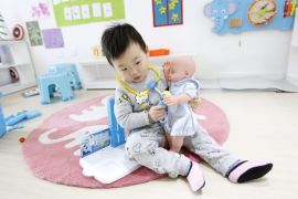 A picture made available on 28 December 2016 shows a Chinese boy playing with a baby doll at Magic International Daycare, a high end child care center in Beijing, China, 22 December 2016. Magic International Daycare is a new high end day care center for children aged zero to four years old, using the Montessori educational method and bilingual programs with local and foreign teachers. While the school features first-rate facilities such as top-tier air filtering machine
