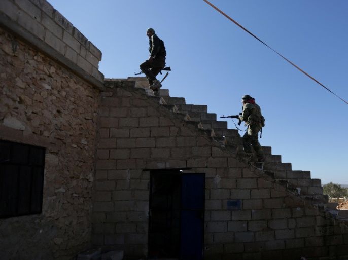 FILE PHOTO: Rebel fighters carry their weapons as they climb a staircase on the outskirts of Al-Bab town in Syria January 22, 2017. REUTERS/Khalil Ashawi/File Photo