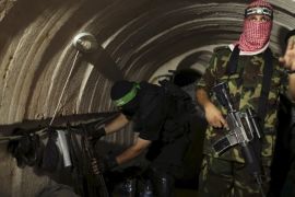 A Palestinian fighter from the Izz el-Deen al-Qassam Brigades, the armed wing of the Hamas movement, gestures inside an underground tunnel in Gaza in this August 18, 2014 file photo. The Israeli government says its investigations have not come up with any evidence the night-time noises reported by villagers living near Gaza emanate from tunnels, but assertions by Hamas of extensive cross-border digging has only fueled concern. REUTERS/Mohammed Salem/Files