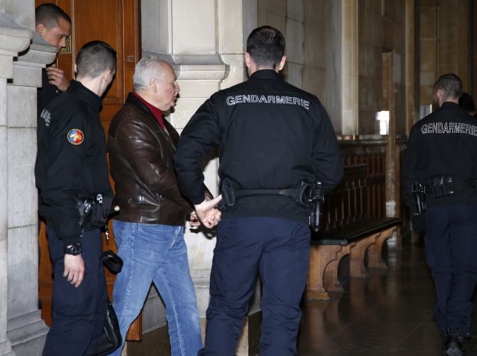 Ilich Ramirez Sanchez, known as "Carlos the Jackal", is surrounded by French gendarmes as he leaves the Paris courthouse March 3, 2014. Carlos the Jackal, the Marxist militant once ranked among the world's most wanted criminals, who currently serves a life sentence in prison, is at court for anti-Semitic insults he made towards a female prison officer. The Venezuelan has been locked up in France for almost 20 years serving an initial life sentence for killing two police officers and an informant in Paris in 1975. REUTERS/Jacky Naegelen (FRANCE - Tags: CRIME LAW)