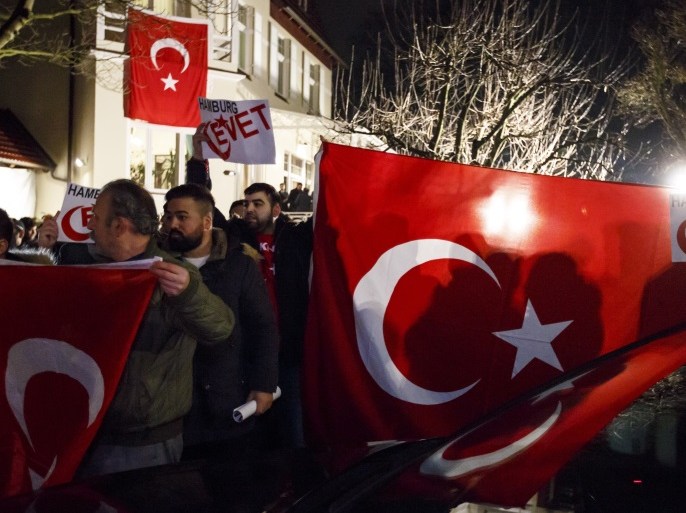 HAMBURG, GERMANY - MARCH 07: Supporters wave flags as Turkish Foreign Minister Mevlut Cavusoglu emerges from the Turkish consulate after speaking to supporters of the upcoming referendum in Turkey on March 7, 2017 in Hamburg, Germany. Turkish government officials have been speaking to expatriate Turks across Germany to rally support for a 'yes' in the upcoming referendum that would give Turkish President Recep Tayyip Erdogan broader powers. German authorities have intervened to cancel at least three of the events due to what they say were safety concerns. Germany and Turkey are experiencing strained relations following the arrest of a German-Turkish journalist in Turkey last month. (Photo by Morris MacMatzen/Getty Images)