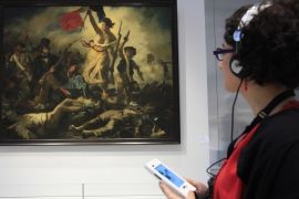 A visitor looks at Eugene Delacroix 's painting,