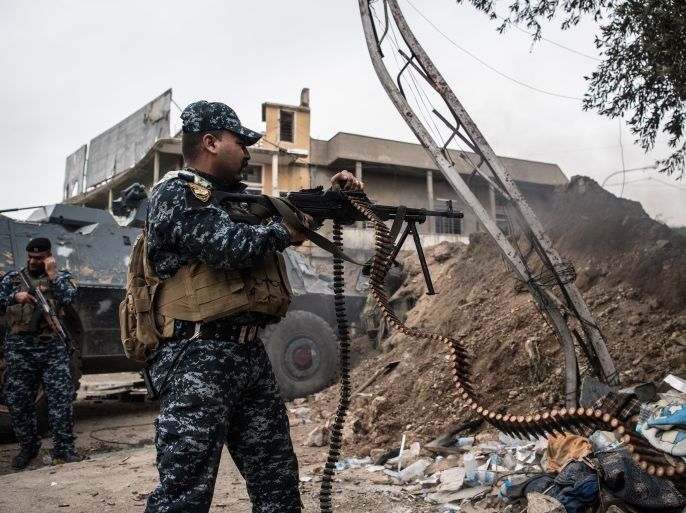 MOSUL, IRAQ - APRIL 13: An Iraqi federal policeman fires a machine gun at an Islamic State position during the battle to recapture west Mosul on April 13, 2017 in Mosul, Iraq. Despite being completely surrounded, Islamic State fighters are continuing to put up stiff resistance to Iraqi forces who are now having to engage I.S in house to house fighting as they continue their battle to retake Iraq's second largest city of Mosul.  (Photo by Carl Court/Getty Images)