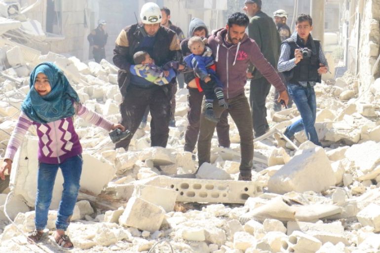 People and a civil defence personnel carry children at a damaged site after an air strike on rebel-held Idlib city, Syria March 19, 2017. REUTERS/Ammar Abdullah TPX IMAGES OF THE DAY