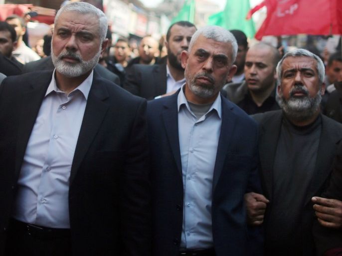 Hamas Gaza Chief Yehya Al-Sinwar (C) and Hamas leader Ismail Haniyeh (L) take part in the funeral of senior militant Mazen Fuqaha in Gaza City March 25, 2017. REUTERS/Mohammed Salem