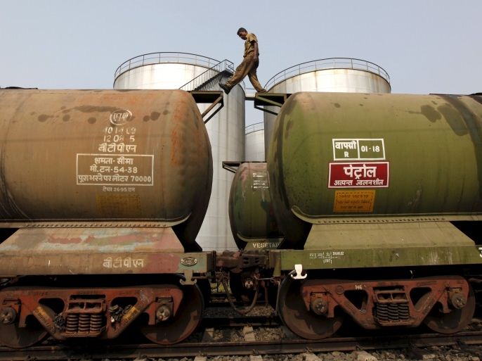 A worker walks atop a tanker wagon to check the freight level at an oil terminal on the outskirts of Kolkata, India in this November 27, 2013 file photo. REUTERS/Rupak De Chowdhuri/Files