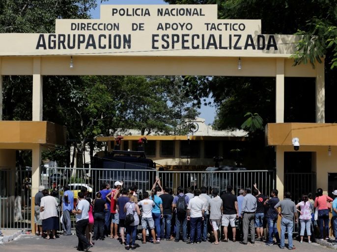 Family members gather outside a police station to inquire about their relatives who were arrested during protests against a possible change in law to allow for presidential re-election in Asuncion, Paraguay April 1, 2017. REUTERS/Jorge Adorno
