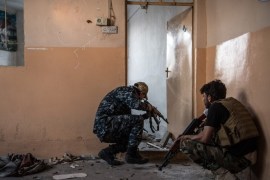 MOSUL, IRAQ - APRIL 07: Iraqi special police officers crouch as they move to a room in a building which is overlooking and in range of an Islamic State sniper during fighting in west Mosul on April 7, 2017 in Mosul, Iraq. Iraqi forces backed by U.S and British air support have entered their sixth month of fighting as they continue the battle to retake the country's second largest city from Islamic state who have held it since 2014. (Photo by Carl Court/Getty Images)