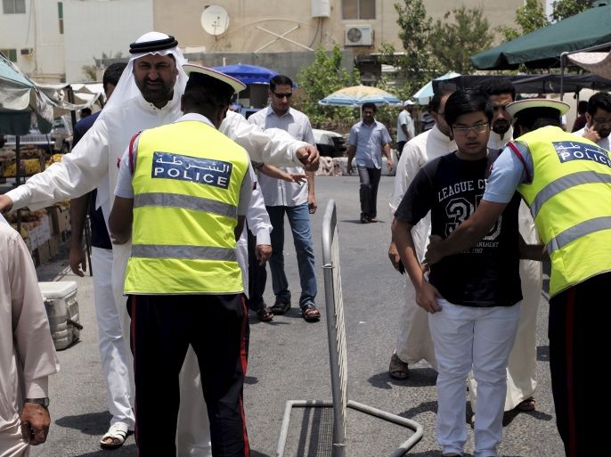 Police searches men as they arrive for Friday prayers at a Shi'ites mosque in the village of Diraz west of Manama, July 31, 2015. Following three bombings of Shi'ite mosques by the Islamic State militant group in Saudi Arabia and Kuwait since May 22, Sunnis and Shi'ites in Kuwait and in Bahrain will pray together in main mosques, as a sign of national unity and in a challenge to the militant group, which is expanding, notably in Egypt, Libya and Yemen, from its stro