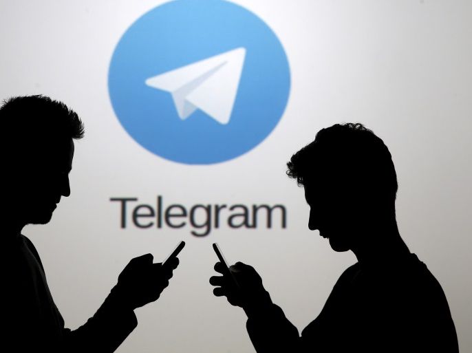 Two men pose with smartphones in front of a screen showing the Telegram logo in this picture illustration taken in Zenica, Bosnia and Herzegovina November 18, 2015. The mobile messaging service Telegram, created by the exiled founder of Russia's most popular social network site, has emerged as an important new promotional and recruitment platform for Islamic State. The service, set up two years ago, has caught on in many corners of the globe as an ultra-secure way to quickly upload and share videos, texts and voice messages. It counts 60 million active users around the world. Picture taken November 18. REUTERS/Dado Ruvic