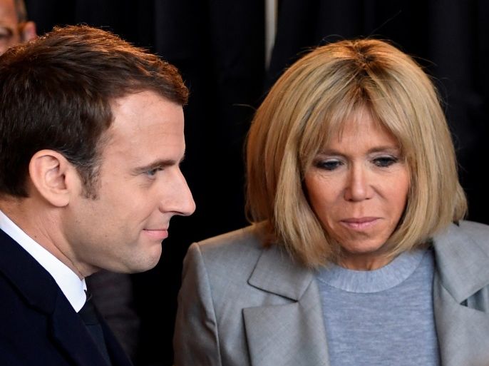 Emmanuel Macron (L), head of the political movement En Marche !, or Onwards !, and candidate for the 2017 French presidential election, and his wife Brigitte Trogneux stand together at a polling station to vote in Le Touquet, northern France, April 23, 2017. REUTERS/Eric Feferberg/Pool