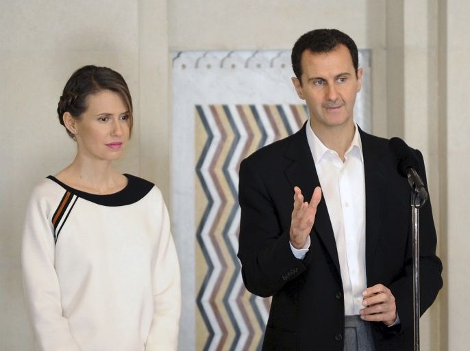 Syria's President Bashar al-Assad stands next to his wife Asma, as he addresses injured soldiers and their mothers during a celebration marking Syrian Mother's Day in Damascus, in this handout picture provided by SANA on March 21, 2016. REUTERS/SANA/Handout via Reuters ATTENTION EDITORS - THIS PICTURE WAS PROVIDED BY A THIRD PARTY. REUTERS IS UNABLE TO INDEPENDENTLY VERIFY THE AUTHENTICITY, CONTENT, LOCATION OR DATE OF THIS IMAGE. FOR EDITORIAL USE ONLY. NOT FOR SALE