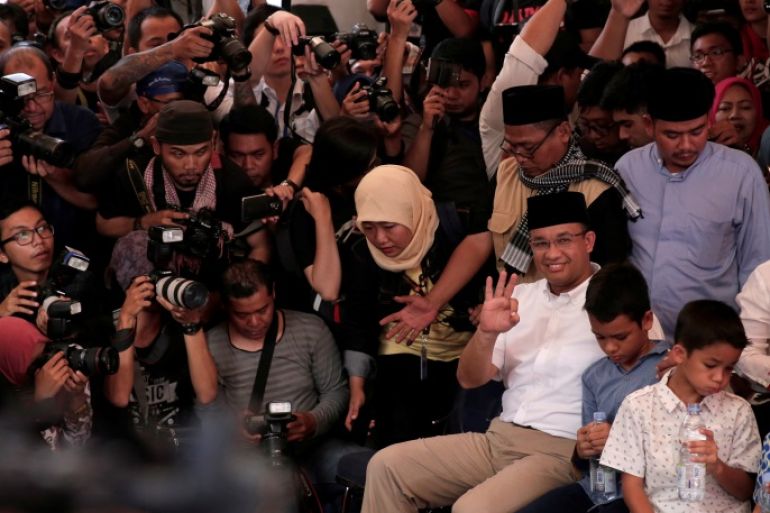 Candidate governor Anies Baswedan sits before casting his vote in the Jakarta governor election in South Jakarta, Indonesia April 19, 2017. REUTERS/Beawiharta