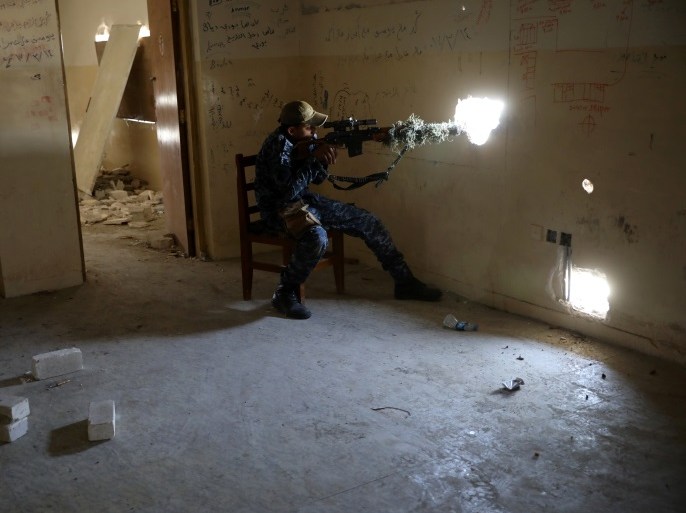 A sniper with the Iraqi Federal Police stays in his position in a sniper's nest of the Iraqi forces fighting the Islamic State in western Mosul, Iraq, April 9, 2017. REUTERS/Andres Martinez Casares