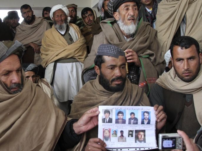 Afghan villagers show a picture of nine men during a protest against U.S. special forces accused of overseeing torture and killings in Wardak province February 26, 2013. More than five hundred men marched through the capital of Afghanistan's restive Wardak province on Tuesday in an outburst of anger against U.S. special forces accused of overseeing torture and killings in the area. A U.S. defence official in Washington said a review in recent months in cooperation with Afghanistan's Defence Ministry and National Directorate of Security (NDS) intelligence agency found no involvement of Western forces in any abuse. The nine men in the photo photo included a shopkeeper, a teacher, a driver and a local government employee, who presidential adviser and former member of parliament Shuja-ul-Mulk Jalala said, based on the testimony of people in the area, were detained at a military outpost in Wardak by U.S. special forces and Afghans identified as translators. REUTERS/Mirwais Harooni (AFGHANISTAN - Tags: CIVIL UNREST POLITICS MILITARY)