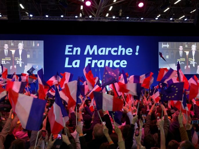 PARIS, FRANCE - APRIL 23: A screen announces the results of the first round of the French Presidential Elections naming Founder and Leader of the political movement 'En Marche !' Emmanuel Macron with 23.7% and National Front Party Leader Marine Le Pen with 22% of the vote at Parc des Expositions Porte de Versailles on April 23, 2017 in Paris, France. Macron and Le Pen will compete in the next round of the French Presidential Elections on May 7 to decide the next Pres