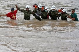 Rescuers walk in the river with chainsaws after flooding and mudslides caused by heavy rains in Mocoa, Colombia April 2, 2017. REUTERS/Jaime Saldarriaga