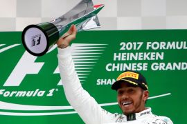 Formula One - F1 - Chinese Grand Prix - Shanghai, China - 09/04/17 - Mercedes driver Lewis Hamilton of Britain celebrates on the podium after winning the Chinese Grand Prix at the Shanghai International Circuit. REUTERS/Aly Song