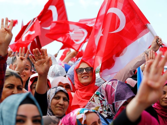 Supporters of Turkish President Tayyip Erdogan hold Turkey's national flags and