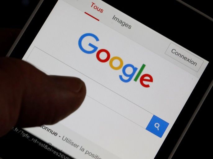 A man holds his smartphone which displays the Google home page, in this picture illustration taken in Bordeaux, Southwestern France, August 22, 2016. REUTERS/Regis Duvignau