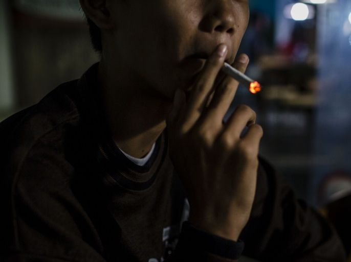 YOGYAKARTA, INDONESIA - MARCH 07: Anggit (14), smokes at a coffee shop with his friends on March 7, 2017 in Yogyakarta, Indonesia. Smoking among Indonesian children has reportedly been on the rise with an estimated 20 million child smokers under the age of 10, according to reports. The Indonesian government recently implemented bans on smoking in public places and prohibitions on cigarette ads to reduce the number of people lighting up although smoking has been ingraine