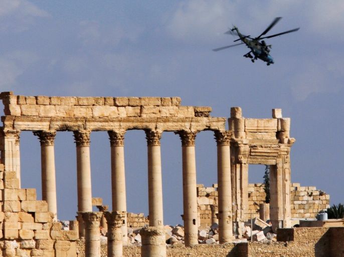 A Russian helicopter flies over the Temple of Bel in the historic city of Palmyra, Syria March 4, 2017. REUTERS/Omar Sanadiki