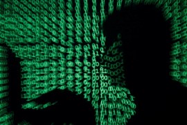 A man holds a laptop computer as cyber code is projected on him in this illustration picture taken on May 13, 2017. Capitalizing on spying tools believed to have been developed by the U.S. National Security Agency, hackers staged a cyber assault with a self-spreading malware that has infected tens of thousands of computers in nearly 100 countries. REUTERS/Kacper Pempel/Illustration