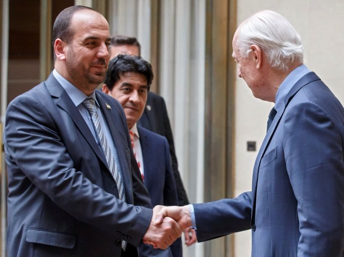 Syria's main opposition High Negotiations Committee (HNC) leader Nasr al-Hariri shakes hands with UN Special Envoy of the Secretary-General for Syria Staffan de Mistura, right, prior a round of negotiation, during the Intra Syria talks, at the European headquarters of the United Nations in Geneva, Switzerland, Tuesday, May 16, 2017. REUTERS/Salvatore Di Nolfi/Pool