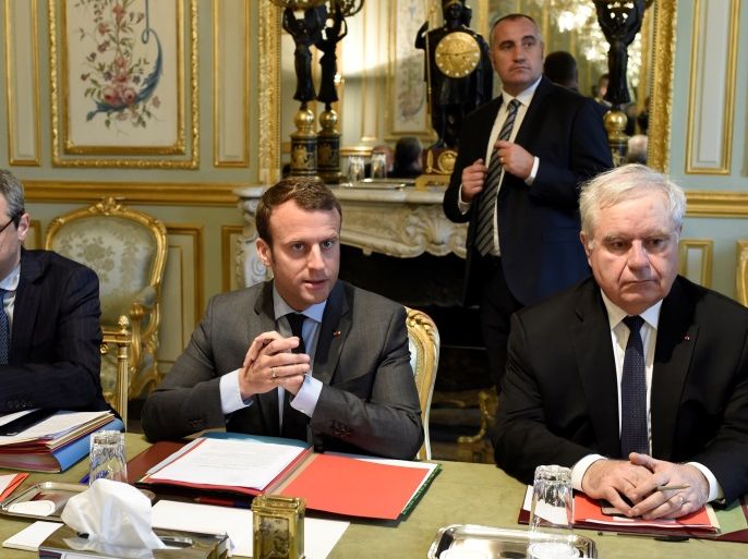 French President Emmanuel Macron (C) sits with Secretary General of the Elysee Palace Alexis Kohler (L) and Admiral Bernard Rogel as they attend a weekly Defense Council at the Elysee Palace in Paris, France, May 24, 2017. REUTERS/Stephane De Sakutin/Pool