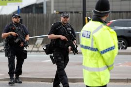 Armed police stand near the Manchester Arena in Manchester, Britain May 24, 2017. REUTERS/Peter Nicholls