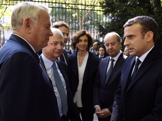 French President elect Emmanuel Macron (R) speaks with French Foreign Minister Jean-Marc Ayrault (L) as French National Assembly speaker Claude Bartolone (2ndL), French Culture Minister Audrey Azoulay (C) and French Justice Minister Jean-Jacques Urvoas (2ndR) listen during a ceremony to mark the anniversary of the abolition of slavery and to pay tribute to the victims of the slave trade at the Jardins du Luxembourg in Paris, France, May 10, 2017. REUTERS/Eric Feferberg/Pool