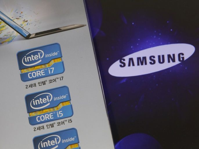 The Samsung Electronics logo is seen on a laptop computer screen (R) in front of an advertisement board promoting Intel processors at a store in Seoul June 21, 2012. Samsung Electronics, already a world leader in TVs and smartphones, is taking the fight to Intel Corp for the No.1 slot in semiconductors, betting on strong growth in so-called logic chips that are the brains inside today's fast-selling smart mobile devices. To match Analysis CHIPS-SAMSUNG/ REUTERS/Cho