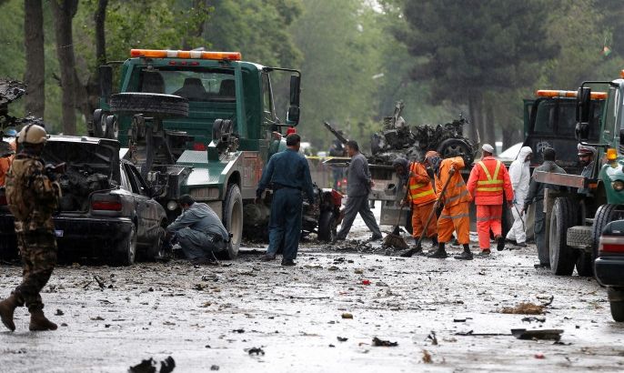 Afghan police and municipal workers clear debris from the site of a suicide bomb attack in Kabul, Afghanistan May 3, 2017. REUTERS/Omar Sobhani