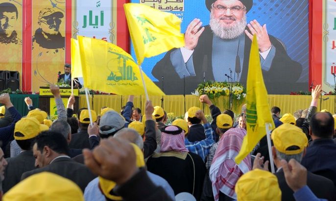 People watch Lebanon's Hezbollah leader Sayyed Hassan Nasrallah as he appears on a screen during a live broadcast to speak to his supporters at an event marking Resistance and Liberation Day, in Bekaa valley May 25, 2016. The event is to commemorate the 16th anniversary of Israel's withdrawal from southern Lebanon. REUTERS/Hassan Abdallah