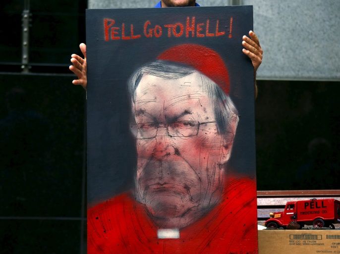 Victims and relatives of children who claim they were sexually abused by the Catholic Church hold placards as they stand outside the venue for Australia's Royal Commission into Institutional Response to Child Sexual Abuse in Sydney, Australia, February 29, 2016. Australian Cardinal George Pell said on Sunday the Catholic Church had made