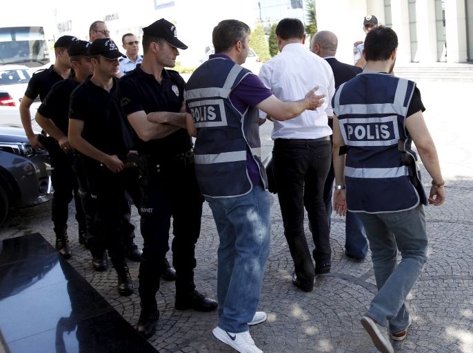 Police officers frisk an employee of the Koza Ipek Group during a raid at the company's office in Ankara, Turkey, September 1, 2015. Turkish police raided the offices of the conglomerate with close links to U.S.-based Muslim cleric Fethullah Gulen, an ally-turned-foe of President Tayyip Erdogan, company officials said on Tuesday. REUTERS/Umit Bektas