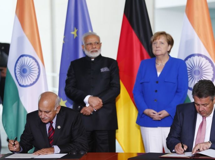 German Foreign Minister Sigmar Gabriel and India's Minister of State for External Affairs Mobashar Jawad Akbar sign documents next to Indian Prime Minister Narendra Modi and German Chancellor Angela Merkel at a ceremony during the 4th round of German-Indian government consultation at the Chancellery in Berlin, Germany, May 30, 2017. REUTERS/Hannibal Hanschke