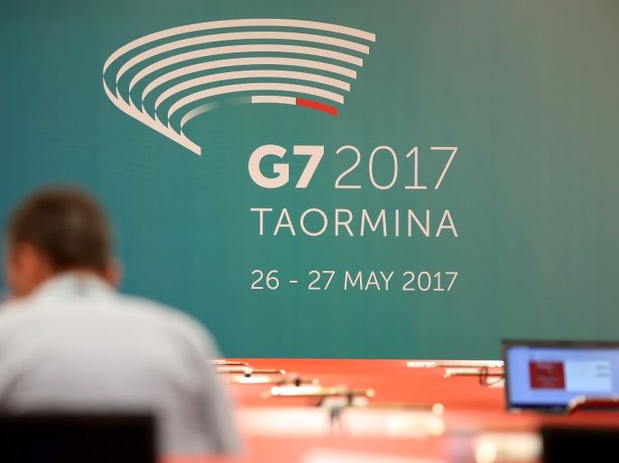 GIARDINI NAXOS, ITALY - MAY 25: A journalist sits near a G7 summit banner in the media center for the G7 Taormina summit on the island of Sicily on May 25, 2017 in Giardini Naxos, Italy. Leaders of the G7 group of nations, which includes the Unted States, Canada, Japan, the United Kingdom, Germany, France and Italy, as well as the European Union, will meet at nearby Taormina from May 26-27. (Photo by Sean Gallup/Getty Images)
